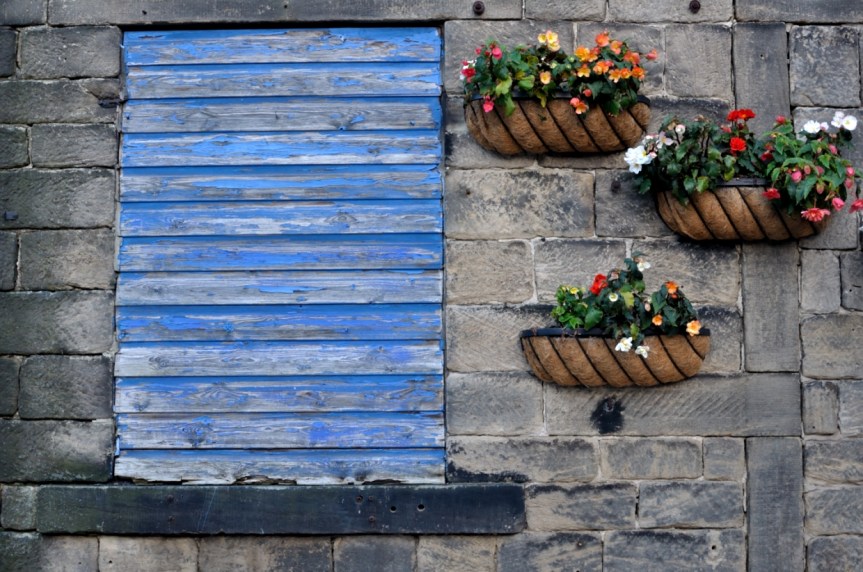 weathered blue boarded-up window