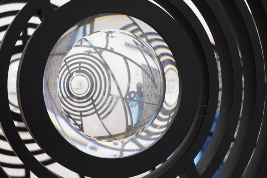 person captured in lens of iron screen