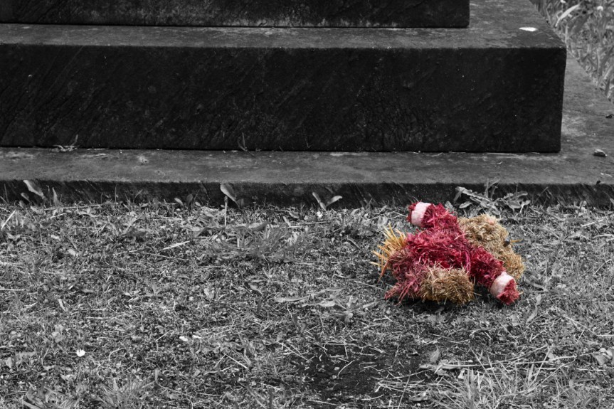 Straw teddy discarded at Undercliffe Cemetery
