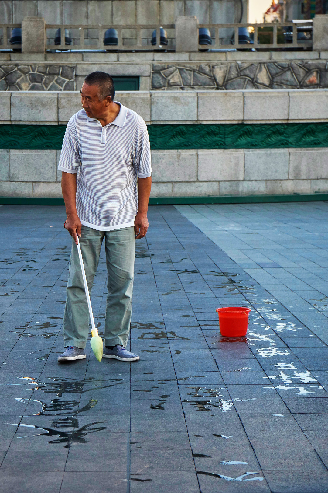 Man writing chinese characters on the street
