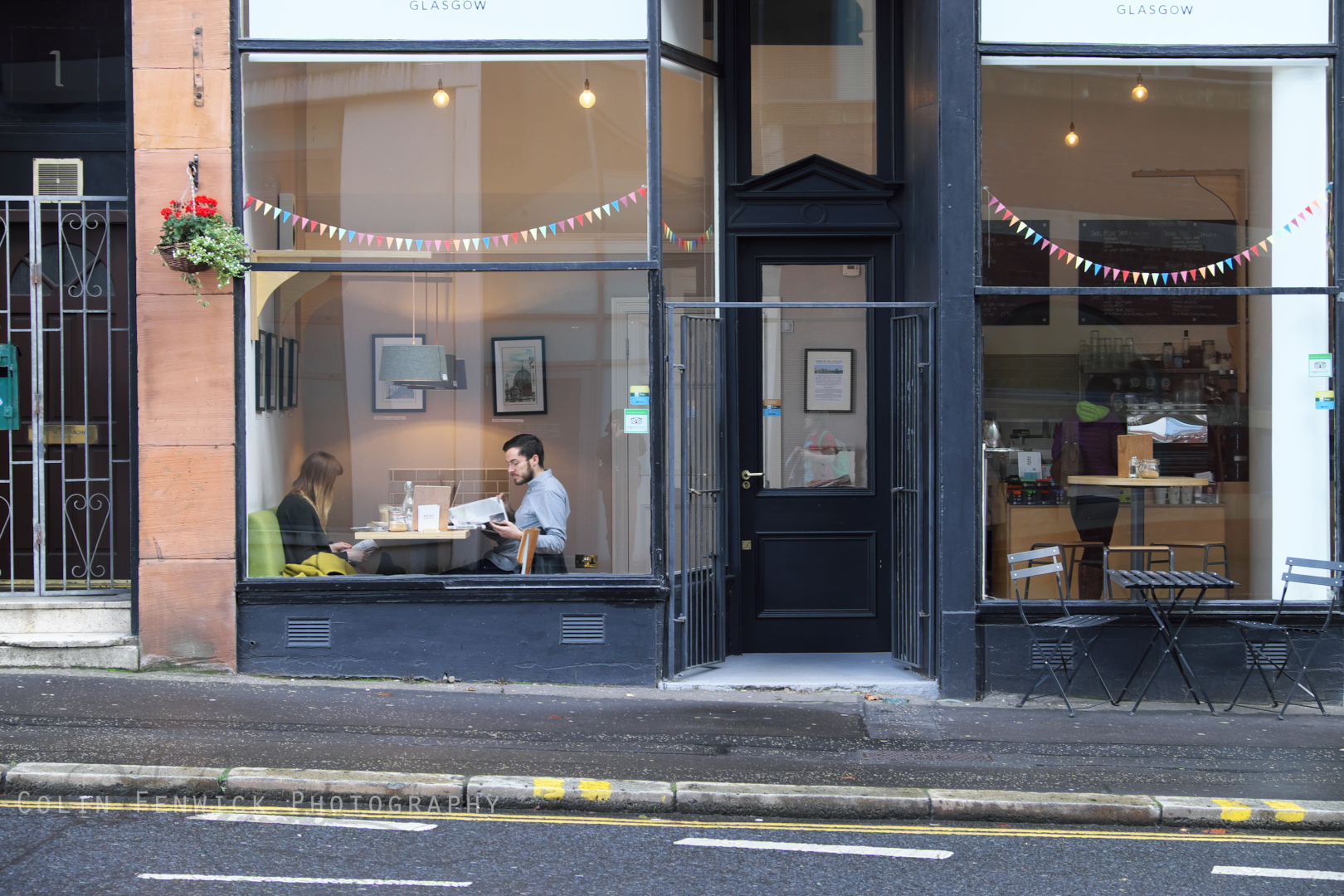 Couple reading newspapers in a cafe