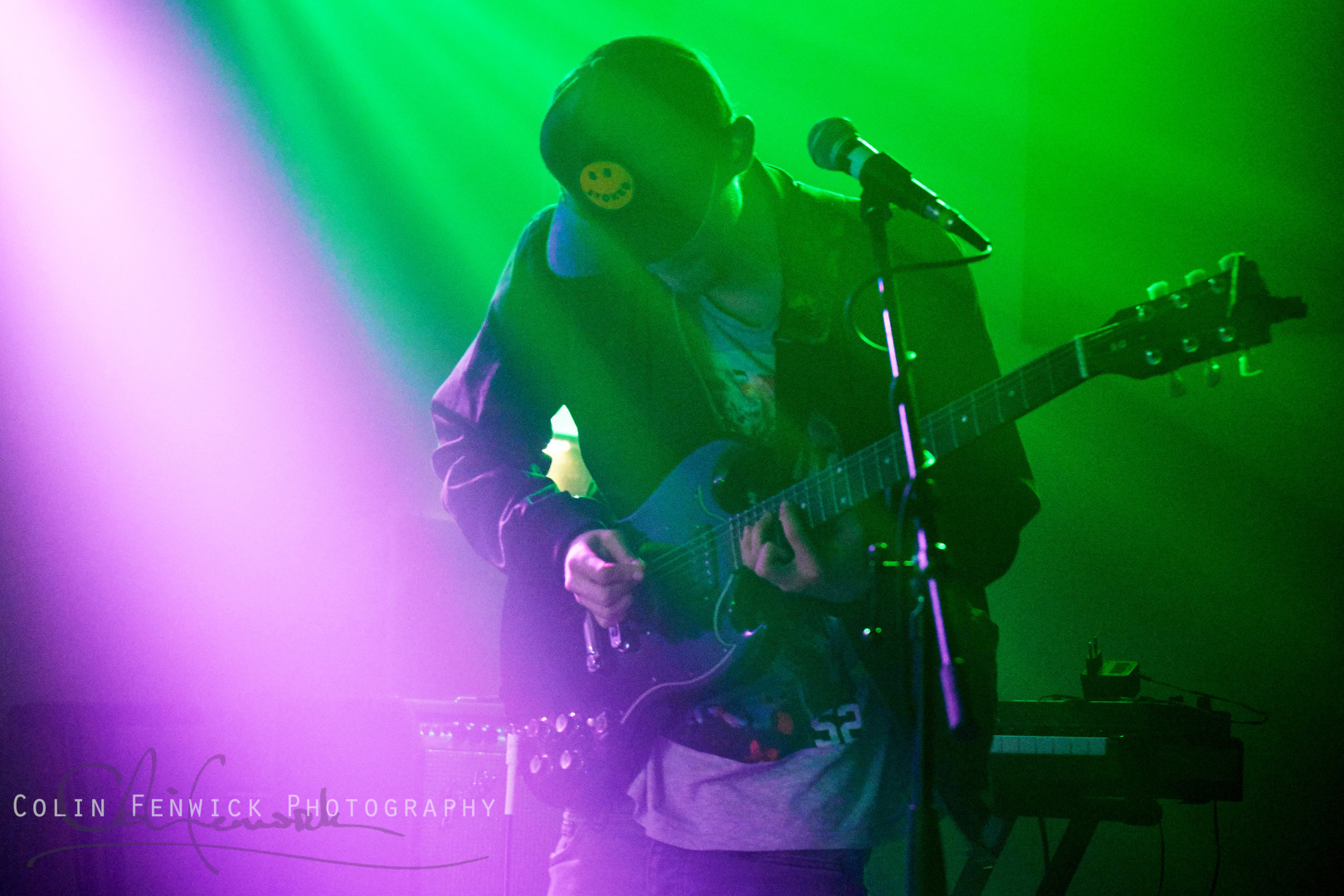 guitar player bathed in coloured lights