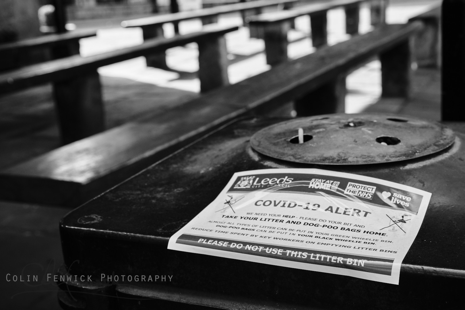 Covid warning sticker on a public bin