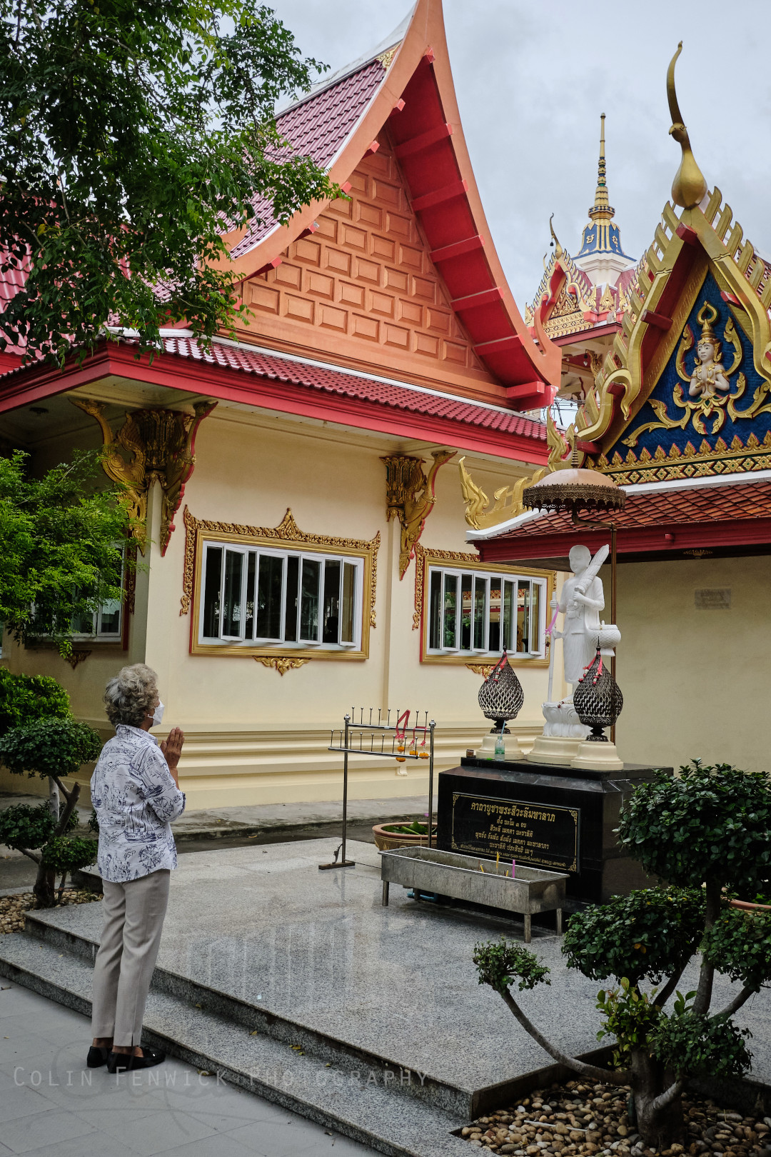 Elderly woman prays at Wat Pa Pradu