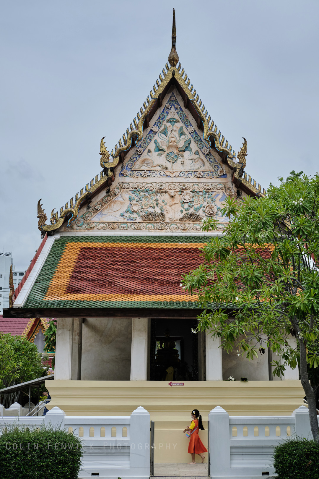 Girl walks around a bosth at Wat Pa Pradu