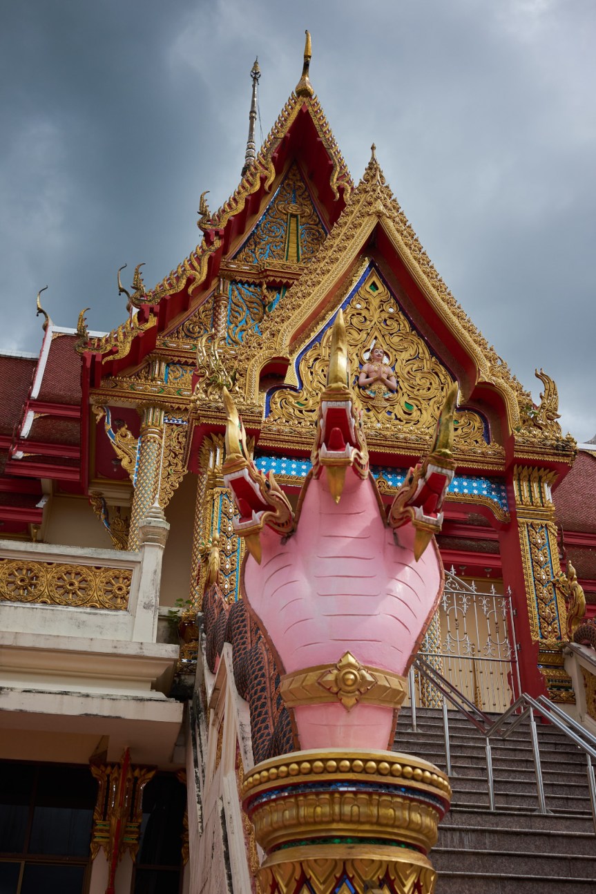 A multi-headed Naga stands guard below the Viharn at Wat Lahan Yai, Rayong, Thailand