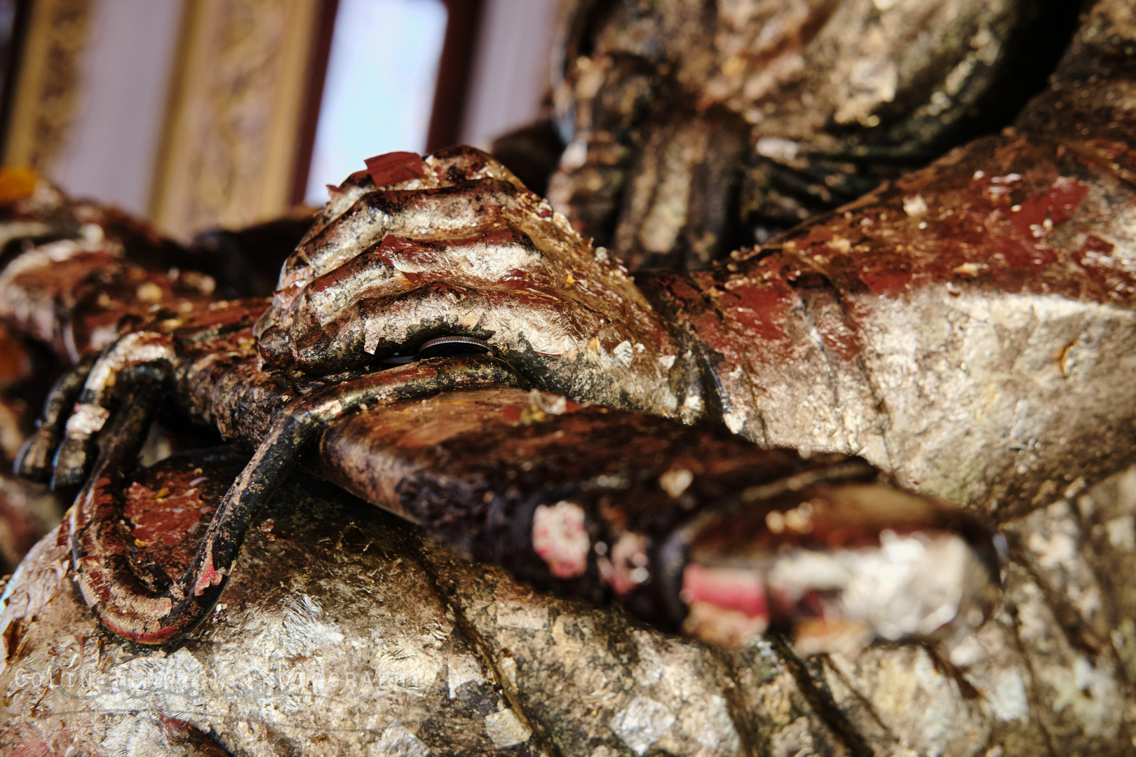 Close up of the Taksin Shrine covered in gold leaf