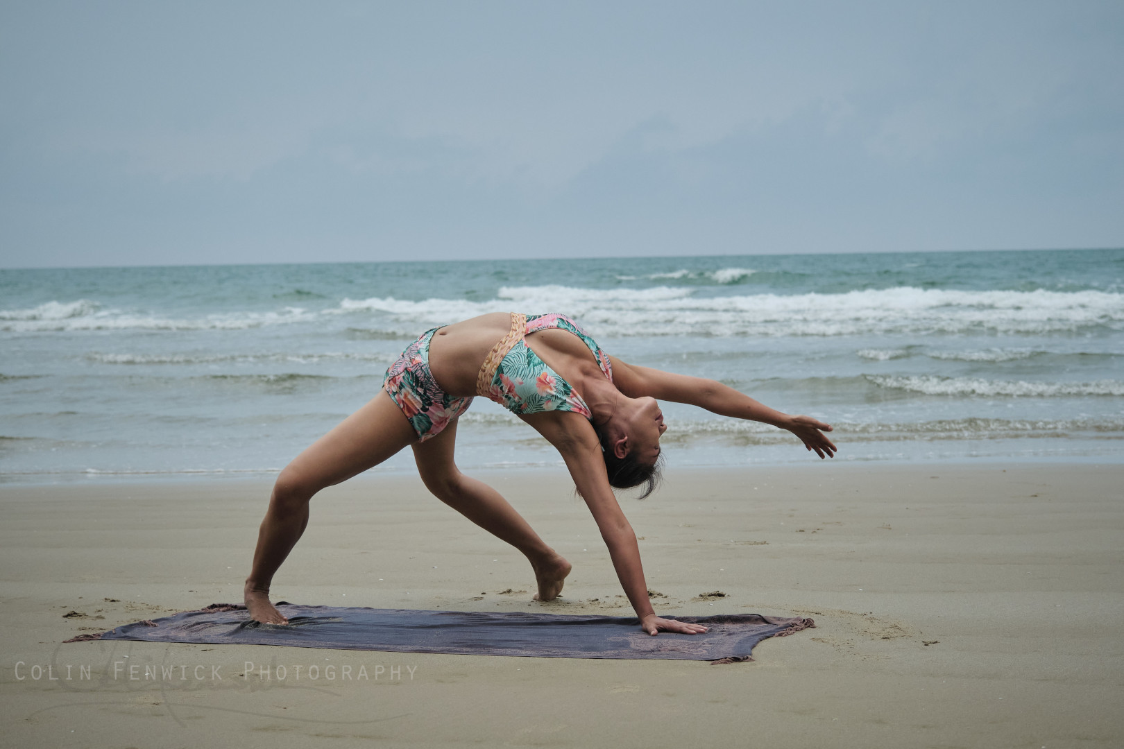 Woman practising Yoga on a beach