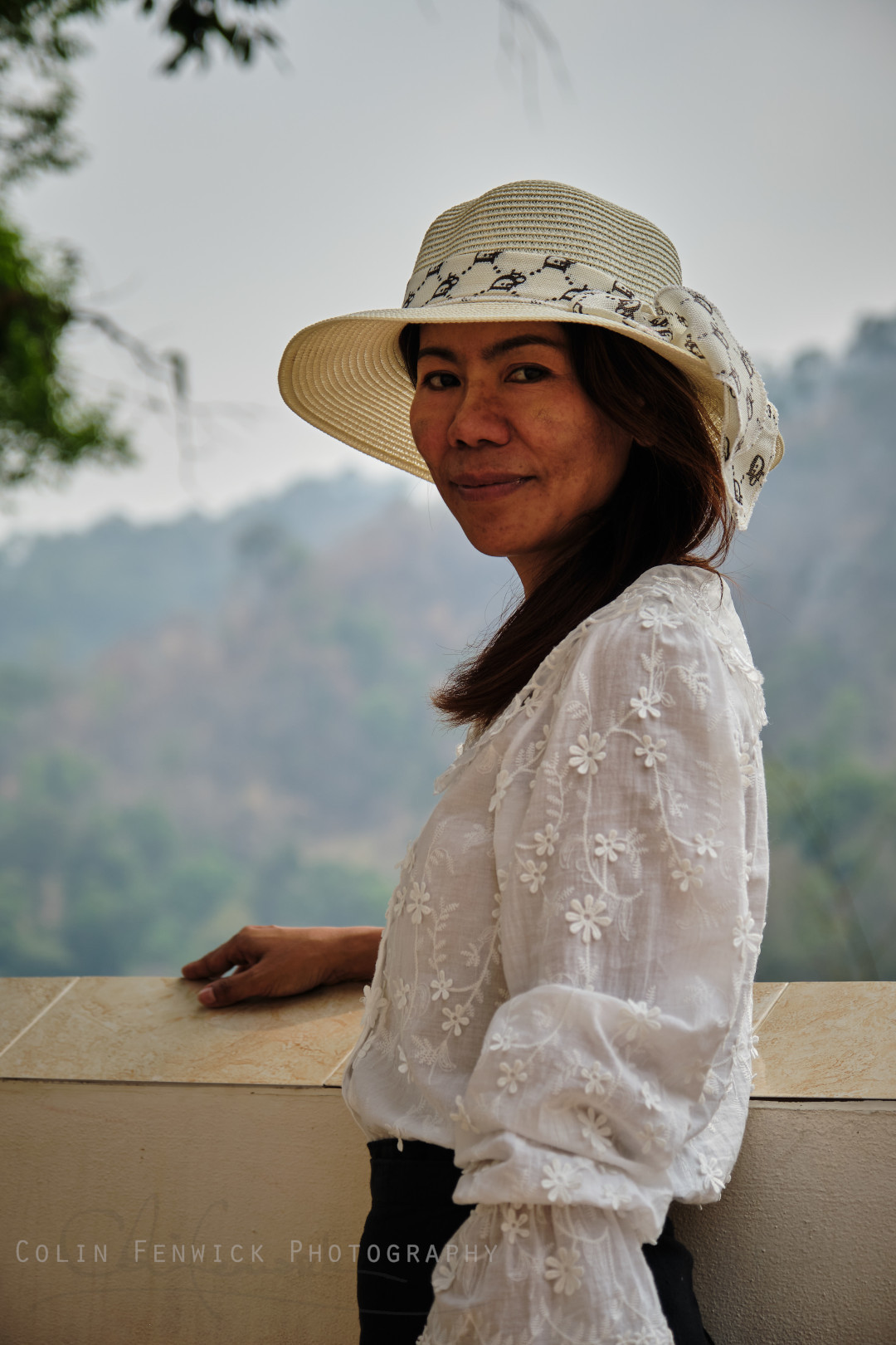 Thai woman poses in front of mountain