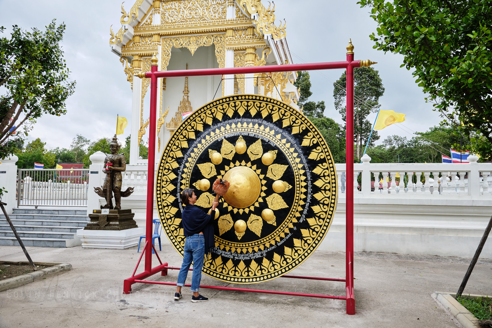 Woman ring a large gong