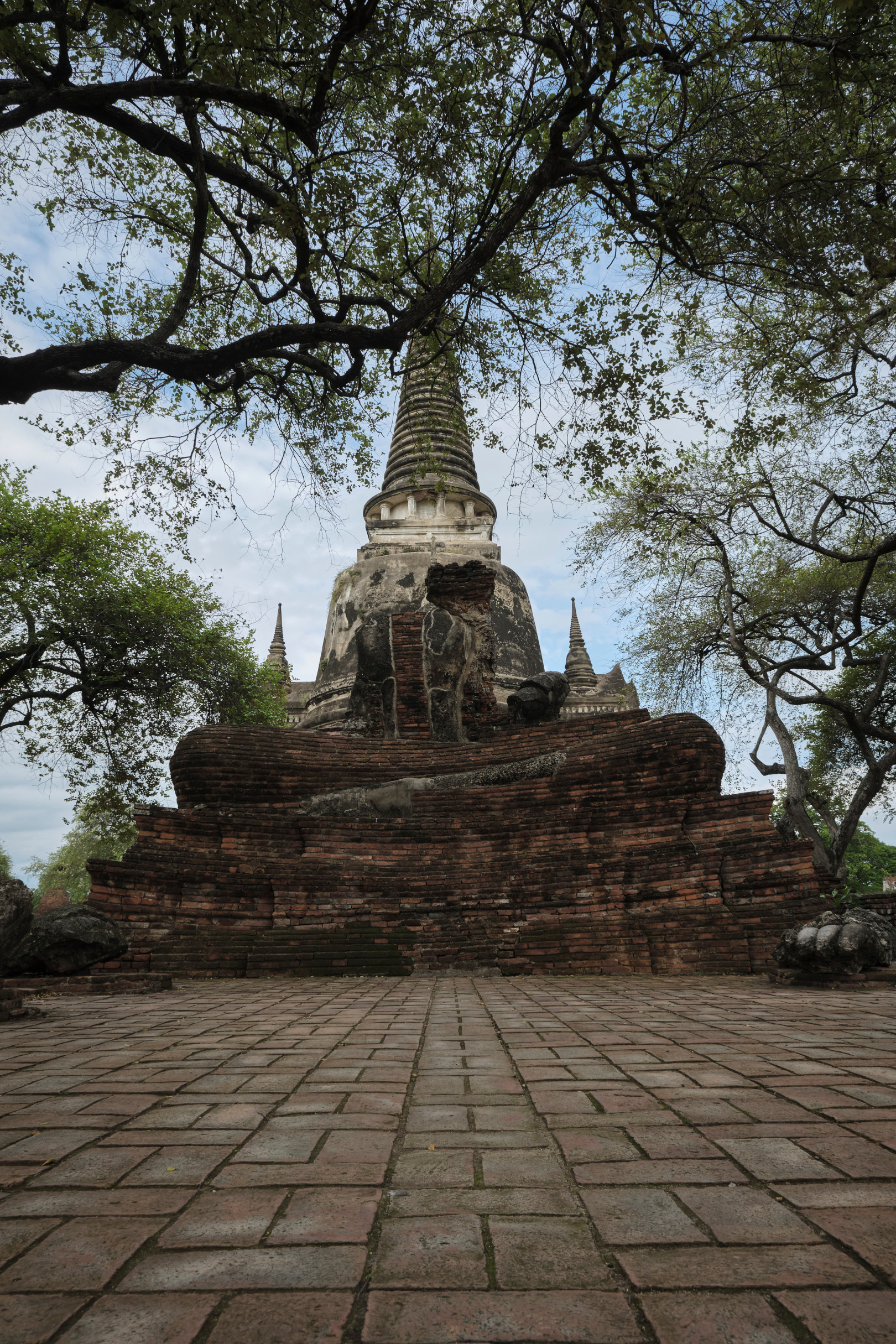 Broken Buddha in front of a Stupa, Ayutthaya Thailand